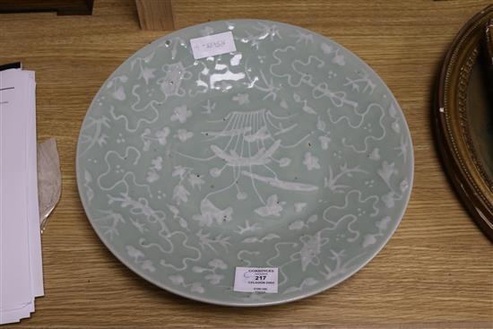 A Chinese white slip decorated celadon dish 35cm.